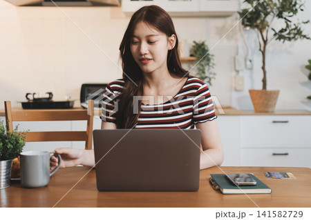 Asian woman using computer remote for business studying, watching online virtual webinar training meeting, video call. asian business woman talking on laptop in home office. Banner, copy space 141582729