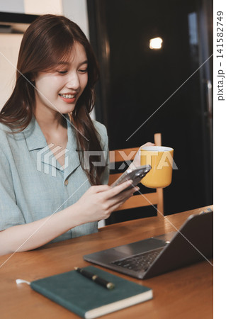 Happiness Entrepreneur beautiful business asian young woman wear casual use mobile phone for shopping online enjoy with social media and laptop at home.Small Business Startup.online banking Happiness Entrepreneur beautiful business asian young woman wear casual use mobile phone for shopping online enjoy with social media and laptop at home.Small Business Startup.online banking 141582749