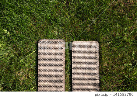 Sadhu board with nails on grass top view yoga meditation practice Sadhu board with nails on grass top view yoga meditation practice 141582790