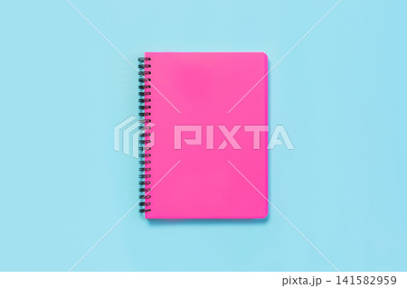 Pink girlish school supplies, notebooks on blue. Top view, flat lay. Copy space. Pink girlish school supplies, notebooks on blue. Top view, flat lay. Copy space. 141582959