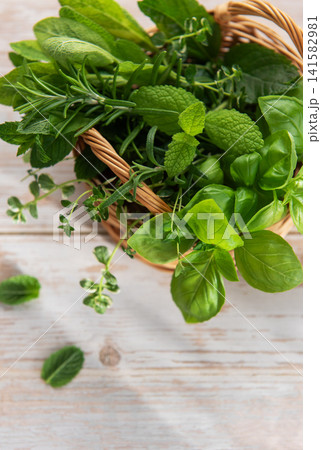 Fresh garden herbs in weaving basket for cooking 141582981