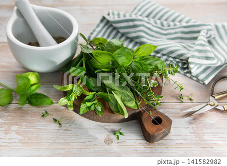 Fresh herbs for cooking with mortar and pestle 141582982
