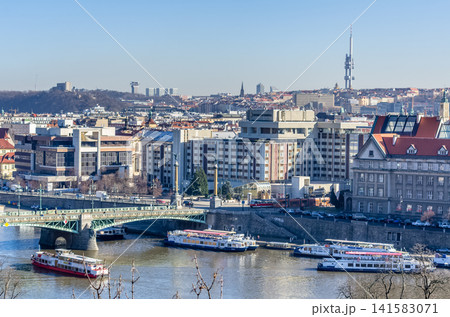 Vltava River panorama with tram crossing Legion Bridge and tour boats in winter, Prague, Czech Republic Vltava River panorama with tram crossing Legion Bridge and tour boats in winter, Prague, Czech Republic 141583071