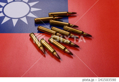 Assault rifle cartridges on the taiwanese flag, serving as a conceptual background for defense Assault rifle cartridges on the taiwanese flag, serving as a conceptual background for defense 141583590