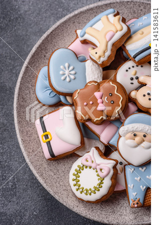 Gingerbread as a Christmas staple, sweet biscuits for the holiday. Gingerbread as a background Gingerbread as a Christmas staple, sweet biscuits for the holiday. Gingerbread as a background 141583611