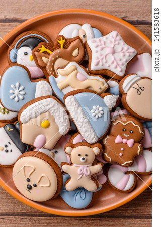 Gingerbread as a Christmas staple, sweet biscuits for the holiday. Gingerbread as a background Gingerbread as a Christmas staple, sweet biscuits for the holiday. Gingerbread as a background 141583618