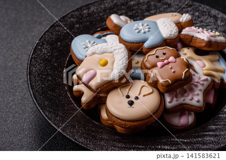 Gingerbread as a Christmas staple, sweet biscuits for the holiday. Gingerbread as a background Gingerbread as a Christmas staple, sweet biscuits for the holiday. Gingerbread as a background 141583621