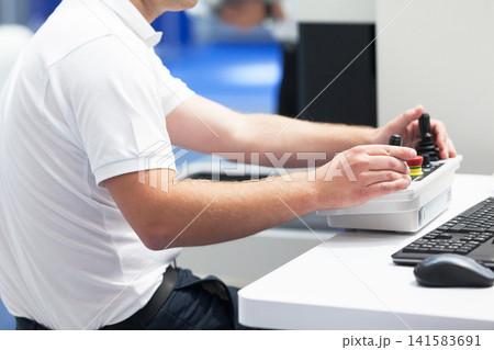 Technician is using joystick to operate electronic device 141583691
