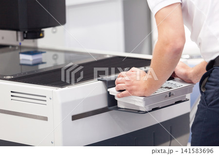 Engineer is using keyboard and joystick to operate electronic device Engineer is using keyboard and joystick to operate electronic device 141583696