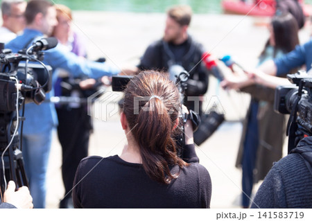 Filming press conference or media event with a video camera Filming press conference or media event with a video camera 141583719