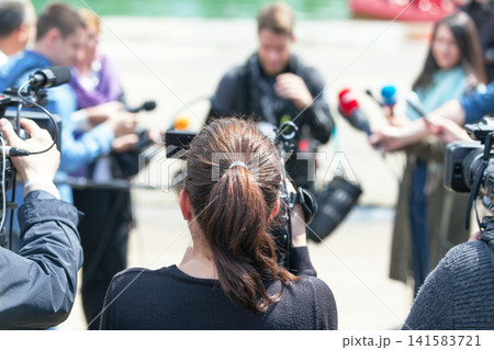 Filming news conference or media event with a video camera Filming news conference or media event with a video camera 141583721