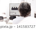 Business person at work, looking at computer monitor 141583727