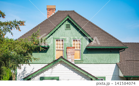 Top of the wooden house with nice windows and chimney in countryside of Canada Top of the wooden house with nice windows and chimney in countryside of Canada 141584074
