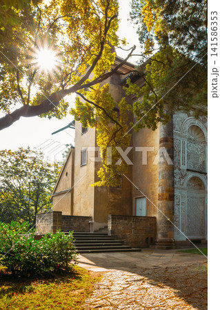 Sun shining through trees at Ball Game Hall in Prague Castle Sun shining through trees at Ball Game Hall in Prague Castle 141586353