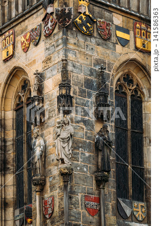 Wall of Prague town hall with astronomical clock, or Prague orloj, Czech Republic. Corner detail of Old Town Hall facade in Prague Wall of Prague town hall with astronomical clock, or Prague orloj, Czech Republic. Corner detail of Old Town Hall facade in Prague 141586363