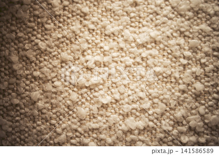 Close-up view of textured beige fabric with small raised fibers creating a soft, tactile surface suitable for upholstery or interior design applications Close-up view of textured beige fabric with small raised fibers creating a soft, tactile surface suitable for upholstery or interior design applications 141586589