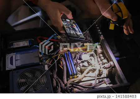 Person assembling high performance gaming computer with liquid cooling 141588403