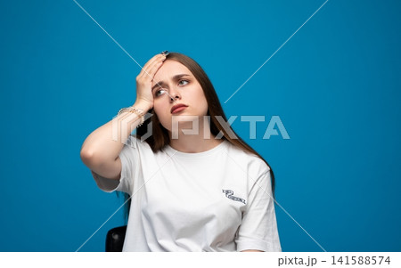 Young woman experiencing severe headache, pain, and stress, feeling unwell with migraine or exhaustion Young woman experiencing severe headache, pain, and stress, feeling unwell with migraine or exhaustion 141588574