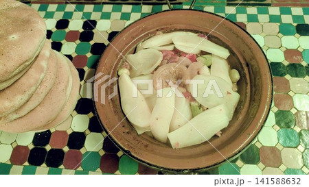Traditional Moroccan Tagine with Sliced Potatoes and Onions Traditional Moroccan Tagine with Sliced Potatoes and Onions 141588632