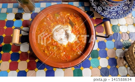 Traditional Moroccan Breakfast Egg Tagine with Vegetables Traditional Moroccan Breakfast Egg Tagine with Vegetables 141588634