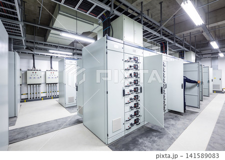 Modern electrical control room with large distribution panels and wiring systems 141589083