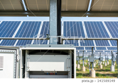 Solar panel array with open electrical control box and wiring detail Solar panel array with open electrical control box and wiring detail 141589149