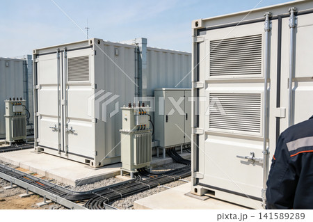 Modern energy storage containers and electrical transformers on a sunny day Modern energy storage containers and electrical transformers on a sunny day 141589289