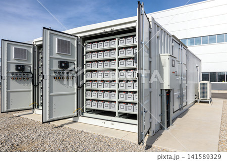 Large industrial battery storage system container with rows of batteries inside 141589329