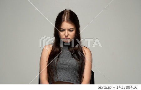Young woman feeling sad and unhappy, pouting with a worried expression, dealing with emotions of disappointment Young woman feeling sad and unhappy, pouting with a worried expression, dealing with emotions of disappointment 141589416