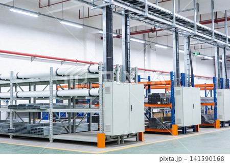 Modern industrial warehouse interior with organized shelving and electrical conduits Modern industrial warehouse interior with organized shelving and electrical conduits 141590168
