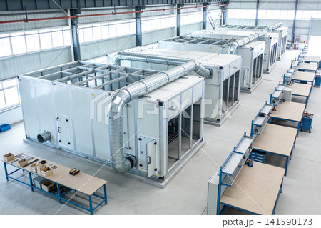 Industrial HVAC units and assembly line workstations in a modern factory setting Industrial HVAC units and assembly line workstations in a modern factory setting 141590173