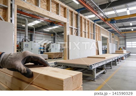 Modern factory producing prefabricated wooden wall elements on an assembly line Modern factory producing prefabricated wooden wall elements on an assembly line 141590329