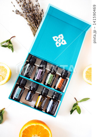 Aromatherapy essential oils kit featuring various bottles arranged in a vibrant box surrounded by fresh citrus fruits and herbs, promoting relaxation and wellness Aromatherapy essential oils kit featuring various bottles arranged in a vibrant box surrounded by fresh citrus fruits and herbs, promoting relaxation and wellness 141590469