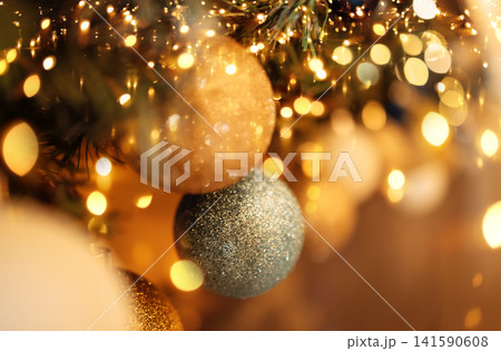 Close-up of gold and silver balls on the Christmas tree. New year card or background. 141590608