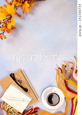 Autumn workspace with coffee, notebooks, and colorful scarf Autumn workspace with coffee, notebooks, and colorful scarf 141590734