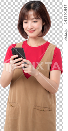 Happy asian woman smiles while engaging with mobile phone. She enjoys modern technology with joyful expression Happy asian woman smiles while engaging with mobile phone. She enjoys modern technology with joyful expression 141591947