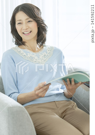 リビングで読書をする中年女性 141592211