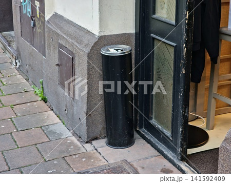 Krakow, Poland - August 6, 2023: Outdoor Ashtray by Open Doorway 141592409