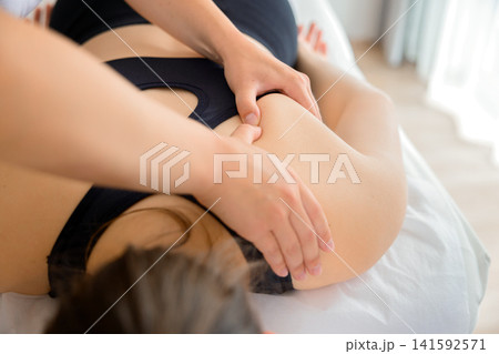 A physician applying manual therapy on a woman patient 141592571