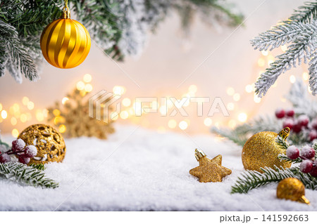 Gold Christmas Ornaments on Snow with Frosted Pine and Berries Gold Christmas Ornaments on Snow with Frosted Pine and Berries 141592663