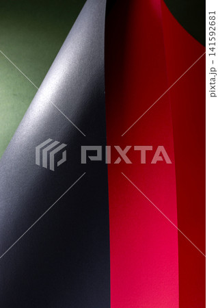 Abstract background of colored paper sheets on a black background Abstract background of colored paper sheets on a black background 141592681