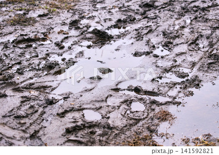 Wet ploughed field in spring: Saturated soil and waterlogged ground ready for the planting season Wet ploughed field in spring: Saturated soil and waterlogged ground ready for the planting season 141592821