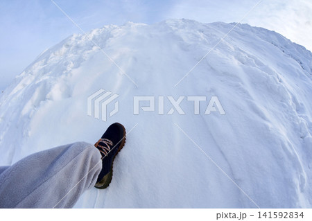 First person POV view of stepping on snowy mountain peak 141592834