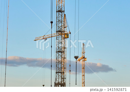 Modern residential apartment buildings under construction with cranes 141592871