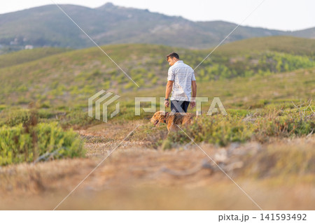 Man walking with airedale terrier in nature Man walking with airedale terrier in nature 141593492
