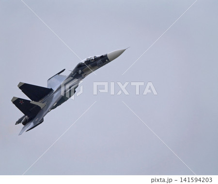 Russia Kubinka 12 April 2025. Su-30SM fighter jet performing aerobatics during an air show. Russian military aircraft executing complex maneuver with smoke trail against blue sky Russia Kubinka 12 April 2025. Su-30SM fighter jet performing aerobatics during an air show. Russian military aircraft executing complex maneuver with smoke trail against blue sky 141594203