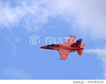 Russia Kubinka 12 April 2025. Yak-130 trainer aircraft performing aerobatics during an air show. Russian combat trainer in flight with smoke trails against blue sky 141594219