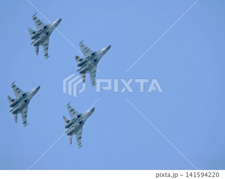 Russia Kubinka 12 April 2025. Russian Knights aerobatic team performing on Su-35 fighter jets during an air show. Military aircraft in formation flight with smoke trails against blue sky Russia Kubinka 12 April 2025. Russian Knights aerobatic team performing on Su-35 fighter jets during an air show. Military aircraft in formation flight with smoke trails against blue sky 141594220