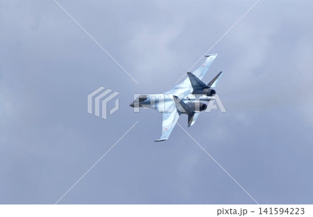 Russia Kubinka 12 April 2025. Russian Knights aerobatic team performing on Su-35 fighter jets during an air show. Military aircraft in formation flight with smoke trails against blue sky Russia Kubinka 12 April 2025. Russian Knights aerobatic team performing on Su-35 fighter jets during an air show. Military aircraft in formation flight with smoke trails against blue sky 141594223