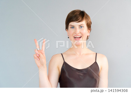 Happy young girl isolated over gray background Happy young girl isolated over gray background 141594308